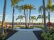 Landscaped area with a walkway and palms at 8933 Amelia Downs Trl, Kissimmee, FL 34747