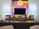 Living room features a large TV and artistic wall decor at 8933 Amelia Downs Trl, Kissimmee, FL 34747