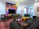 Stylish living room with vibrant wall art, comfy seating and large TV at 8933 Amelia Downs Trl, Kissimmee, FL 34747