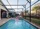Inviting pool and spa with a screened enclosure at 8933 Amelia Downs Trl, Kissimmee, FL 34747