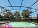 Relaxing pool area at night with flamingo floats and string lights at 8933 Amelia Downs Trl, Kissimmee, FL 34747
