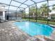 Inviting screened pool and spa with brick pavers at 8933 Amelia Downs Trl, Kissimmee, FL 34747