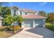 Two-story house with two-car garage and landscaping at 944 Torrey Pine Dr, Winter Springs, FL 32708