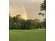 Rainbow over a lush green golf course surrounded by trees at 944 Torrey Pine Dr, Winter Springs, FL 32708
