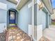 Front entrance with blue door, tile walkway, and garage at 944 Torrey Pine Dr, Winter Springs, FL 32708
