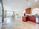 Open concept kitchen and dining area with wood cabinets and tile floors at 944 Torrey Pine Dr, Winter Springs, FL 32708