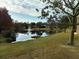 Serene pond view with lush landscaping and fountain at 944 Torrey Pine Dr, Winter Springs, FL 32708