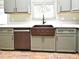 Farmhouse sink and stainless steel dishwasher in a modern kitchen at 1006 Aviles Ct, Oviedo, FL 32765