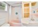 Bathroom with pink tub, white sink, and tiled walls at 1217 Magnolia Ave, Sanford, FL 32771