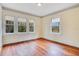 Bright bedroom featuring hardwood floors and large windows at 1217 Magnolia Ave, Sanford, FL 32771
