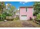 Pink house with garage and fenced backyard at 1217 Magnolia Ave, Sanford, FL 32771