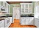 White kitchen with gas range, granite counters, and hardwood floors at 1217 Magnolia Ave, Sanford, FL 32771