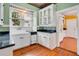 Charming kitchen with white cabinets, granite counters, and hardwood floors at 1217 Magnolia Ave, Sanford, FL 32771