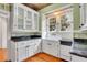 White kitchen cabinets, granite countertops, and hardwood floors at 1217 Magnolia Ave, Sanford, FL 32771