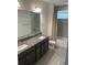 Bathroom with double vanity, granite countertop, and tiled floor at 13007 Bromborough Dr, Orlando, FL 32832