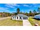 New construction home with a gray roof and driveway at 14949 Sw 65Th Avenue Rd, Ocala, FL 34473