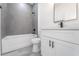 Bathroom with grey tile shower, white vanity, and a toilet at 14949 Sw 65Th Avenue Rd, Ocala, FL 34473