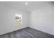 Simple bedroom with grey flooring and a window at 14949 Sw 65Th Avenue Rd, Ocala, FL 34473