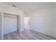 Bright bedroom with grey wood flooring and a closet at 14949 Sw 65Th Avenue Rd, Ocala, FL 34473