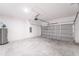 Attached garage featuring concrete floor and storage at 14949 Sw 65Th Avenue Rd, Ocala, FL 34473