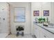 Elegant bathroom featuring double sinks and a walk-in shower at 1528 Ellesmere Ave, Haines City, FL 33844