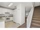 Kitchen with white cabinets, granite countertops, and a view of the stairs at 159 Deepcove Rd, Winter Garden, FL 34787