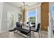 Modern dining area with glass table and black leather chairs at 160 Jetty Way, Davenport, FL 33897