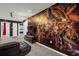 Game room featuring a large Avengers mural, TV, and comfortable seating at 160 Jetty Way, Davenport, FL 33897