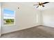 Bedroom with window offering distant views and ceiling fan at 225 W Seminole Blvd # 512, Sanford, FL 32771