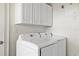 Laundry room with washer, dryer, and upper cabinets at 225 W Seminole Blvd # 512, Sanford, FL 32771