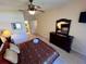King-size bed, dresser, and access to en-suite bathroom at 2306 Silver Palm Dr # 103, Kissimmee, FL 34747