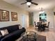 Bright living room features a comfy sofa and a view into the dining area at 2306 Silver Palm Dr # 103, Kissimmee, FL 34747
