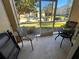 Screened-in patio with table and chairs at 2306 Silver Palm Dr # 103, Kissimmee, FL 34747