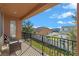 Balcony with seating overlooking fenced backyard and neighborhood at 2731 Flintlock Ave, Clermont, FL 34711