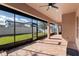 Screened-in covered patio with brick pavers and view of the backyard at 2731 Flintlock Ave, Clermont, FL 34711