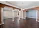Elegant dining room with wood-look tile flooring, columns, and an open floor plan at 2731 Flintlock Ave, Clermont, FL 34711