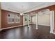Formal dining room with wood-look tile flooring, decorative columns, and tray ceiling at 2731 Flintlock Ave, Clermont, FL 34711
