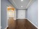 Spacious foyer with wood-look tile flooring, decorative columns, and arched doorways at 2731 Flintlock Ave, Clermont, FL 34711