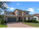 Inviting two-story house with a paver driveway and well-maintained landscaping at 2731 Flintlock Ave, Clermont, FL 34711