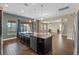 Kitchen island with sink, dishwasher, and view of the adjacent living room at 2731 Flintlock Ave, Clermont, FL 34711