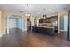 Modern kitchen with dark wood cabinets, stainless steel appliances, and large island at 2731 Flintlock Ave, Clermont, FL 34711