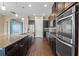 Modern kitchen with stainless steel appliances, granite countertops and dark cabinets at 2731 Flintlock Ave, Clermont, FL 34711