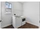 Laundry room with white washer and dryer, shelving, and tile floor at 2731 Flintlock Ave, Clermont, FL 34711