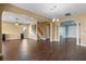 Open concept living and dining area with wood-look tile and columns at 2731 Flintlock Ave, Clermont, FL 34711