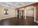 Spacious living room with columns, dark wood-look tile, and recessed lighting at 2731 Flintlock Ave, Clermont, FL 34711