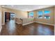Open loft area with wood laminate flooring, multiple windows, and neutral walls at 2731 Flintlock Ave, Clermont, FL 34711
