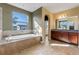 Main bathroom with soaking tub, separate shower, and double vanity at 2731 Flintlock Ave, Clermont, FL 34711