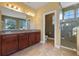 Main bathroom featuring dual vanity, glass shower, and tile floors at 2731 Flintlock Ave, Clermont, FL 34711