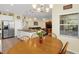 Casual dining area with wood table and chairs, near kitchen at 497 Lakepark Trl, Oviedo, FL 32765