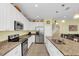 Well-equipped kitchen with white cabinets and granite countertops at 497 Lakepark Trl, Oviedo, FL 32765